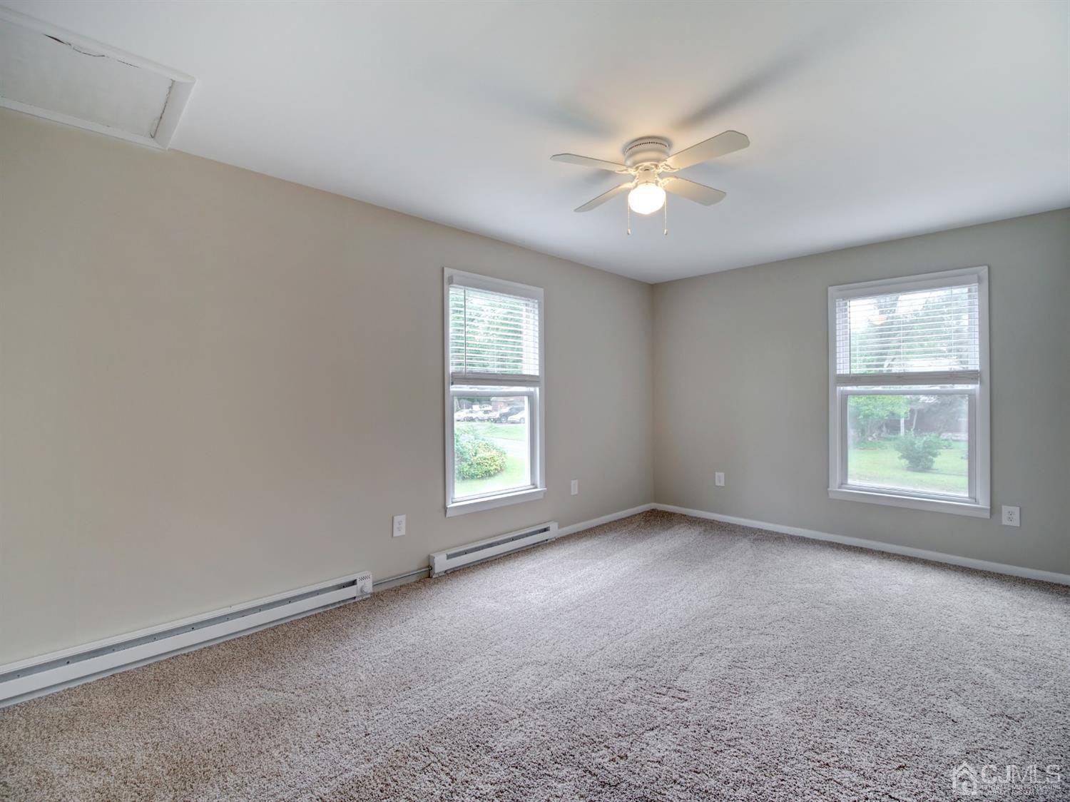 80 Pleasant Valley Road Old Bridge, NJ 08857 - Photo 9 of 15 an empty room with windows and chandelier fan
