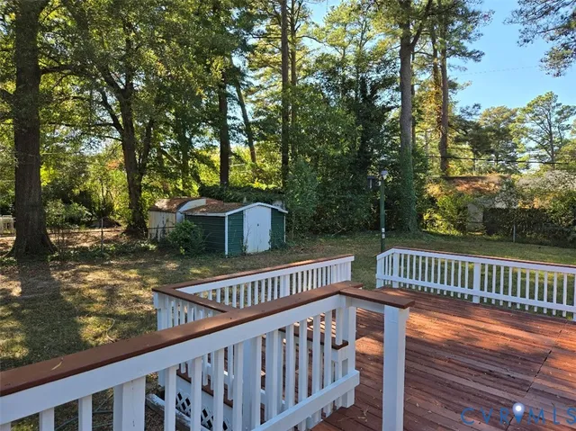 a view of a wooden deck and a yard