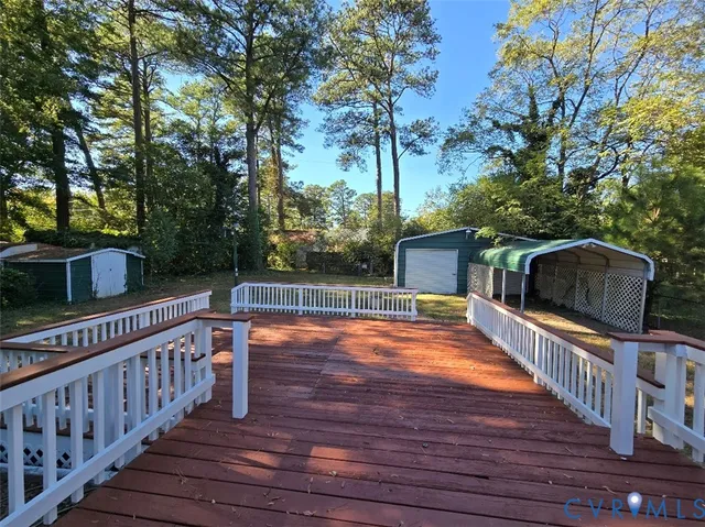 a balcony with wooden floor and potted plants