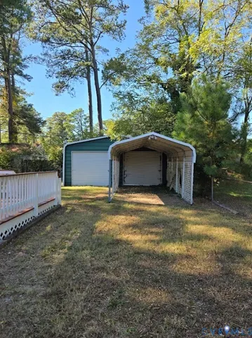 a view of a backyard with large trees