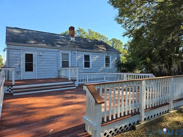 a roof deck with wooden floor and fence