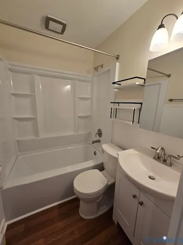 a bathroom with a toilet a sink and bathtub