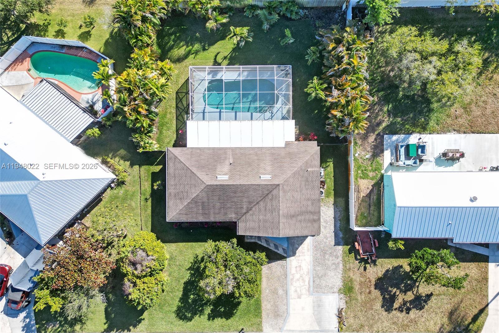 an aerial view of a house with a yard and garden