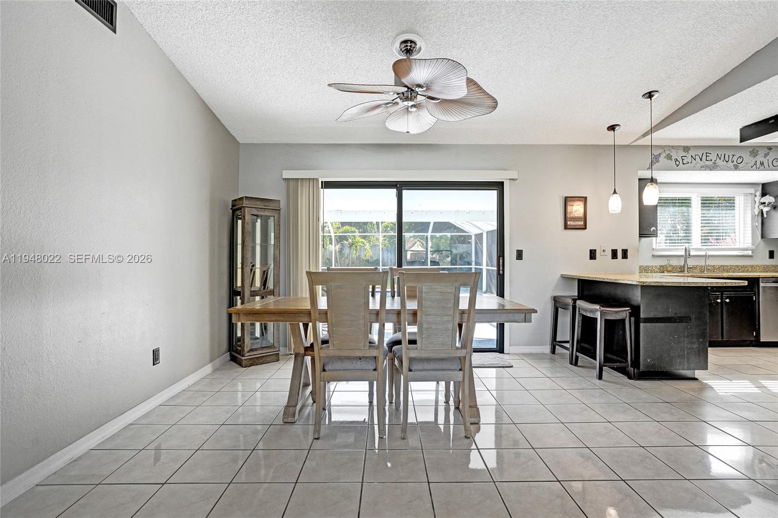 2252 Southeast Rainier Road Port St. Lucie, FL 34952 - Photo 11 of 52 a view of a dining room with furniture and chandelier