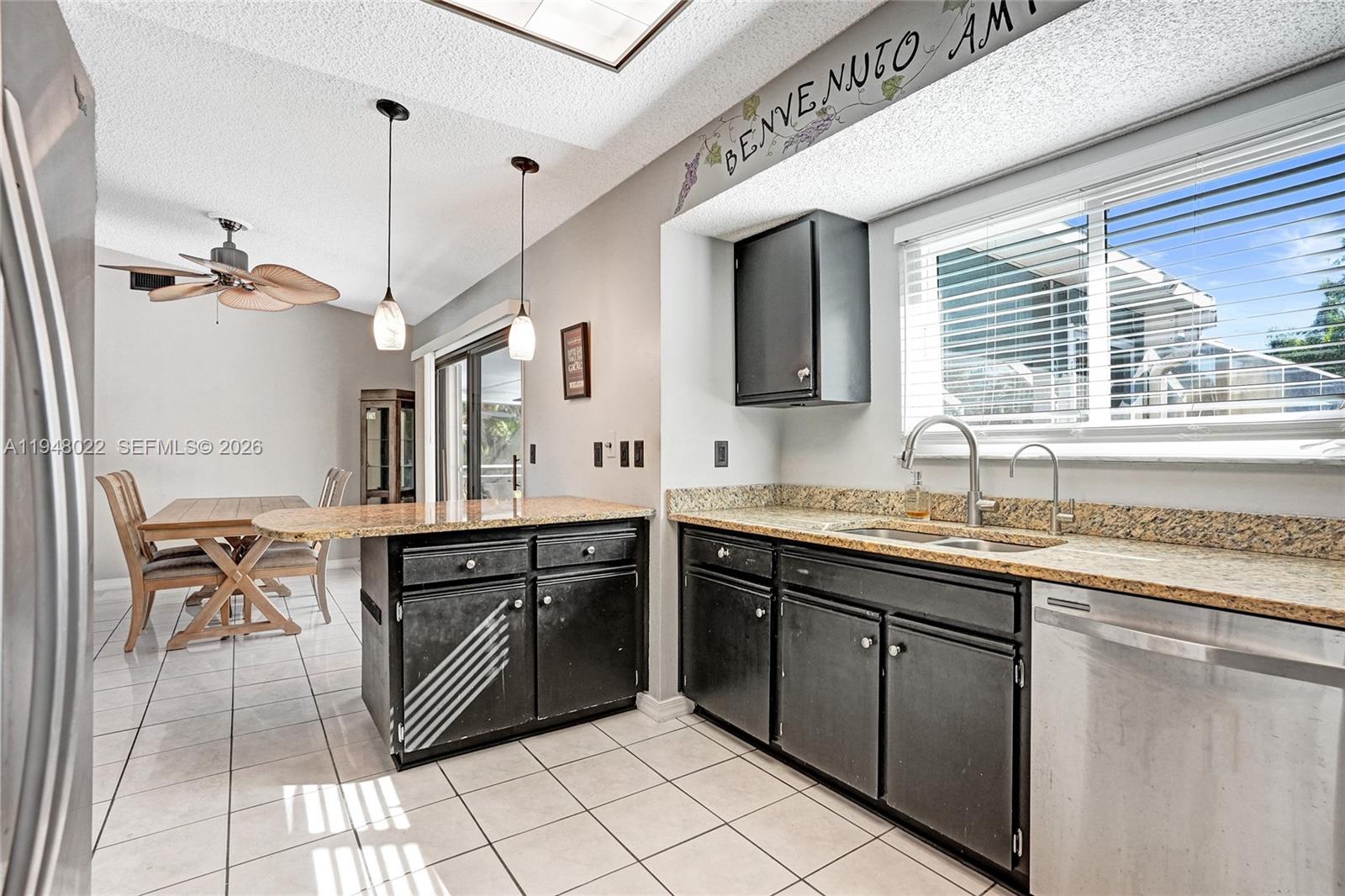 2252 Southeast Rainier Road Port St. Lucie, FL 34952 - Photo 20 of 52 a kitchen with stainless steel appliances granite countertop a sink and a refrigerator