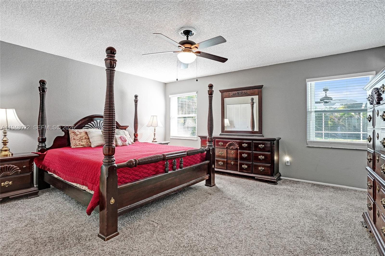 2252 Southeast Rainier Road Port St. Lucie, FL 34952 - Photo 21 of 52 a bedroom with a bed and a ceiling fan