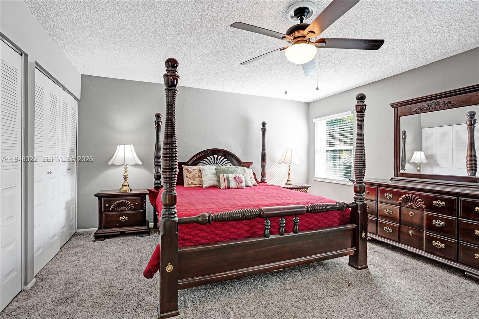 2252 Southeast Rainier Road Port St. Lucie, FL 34952 - Photo 22 of 52 a bedroom with a bed and a chandelier