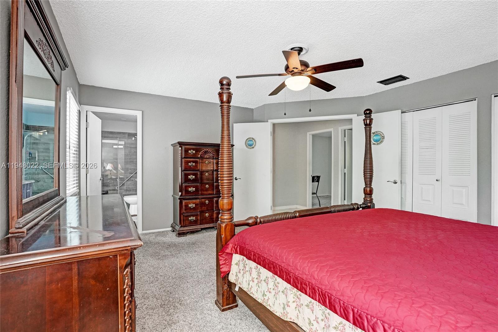 2252 Southeast Rainier Road Port St. Lucie, FL 34952 - Photo 24 of 52 a bedroom with a large bed and a chandelier