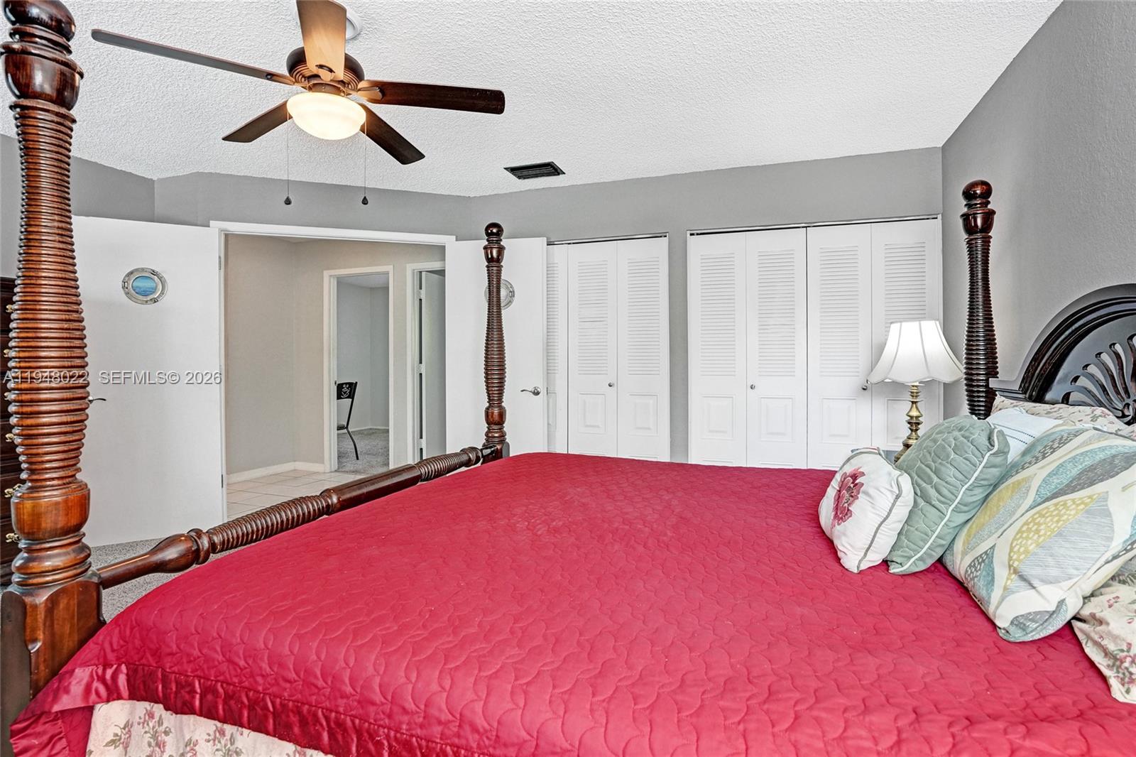 2252 Southeast Rainier Road Port St. Lucie, FL 34952 - Photo 25 of 52 a bedroom with a bed and a chandelier