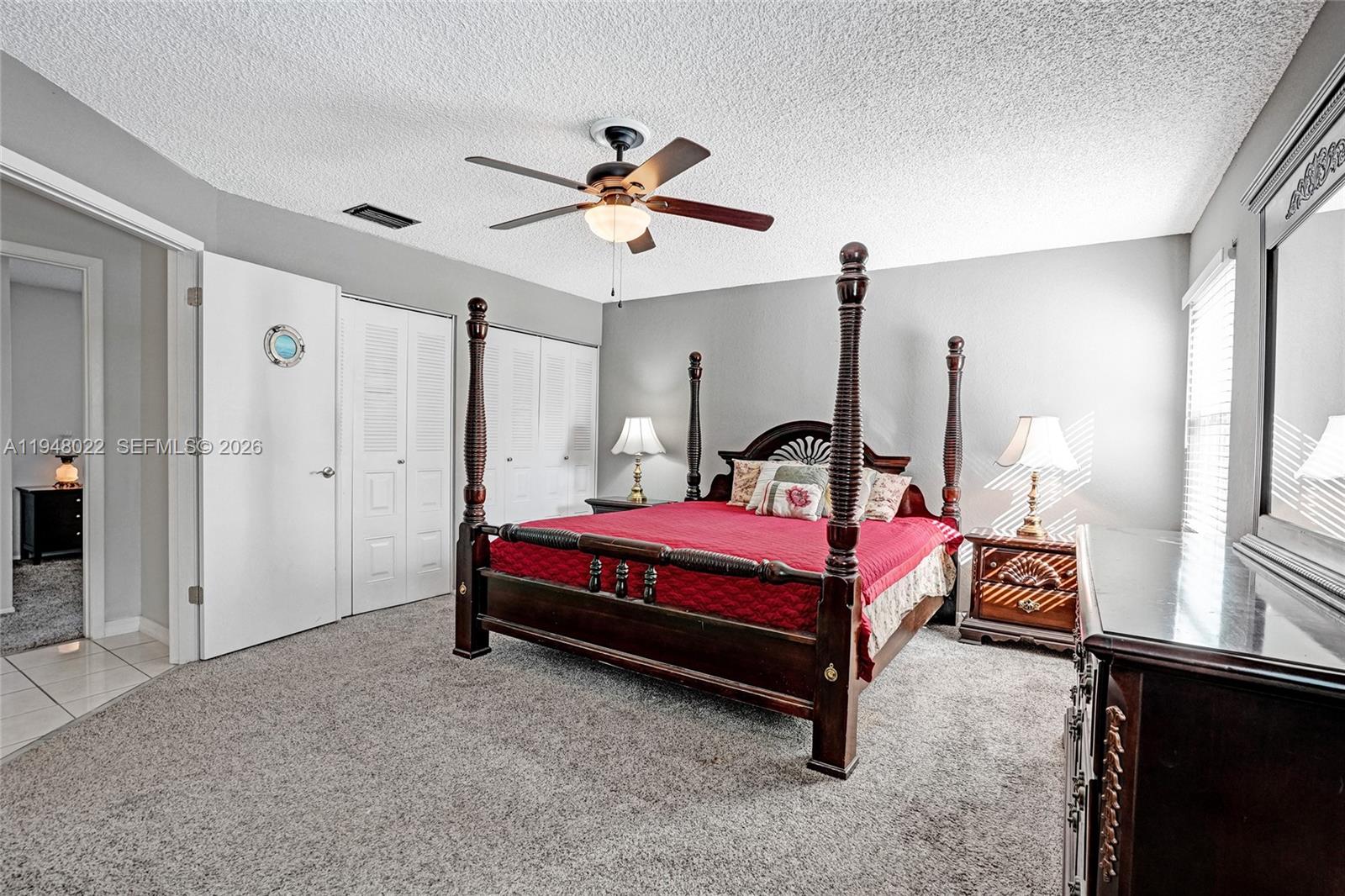 2252 Southeast Rainier Road Port St. Lucie, FL 34952 - Photo 26 of 52 a bedroom with a bed and a chandelier