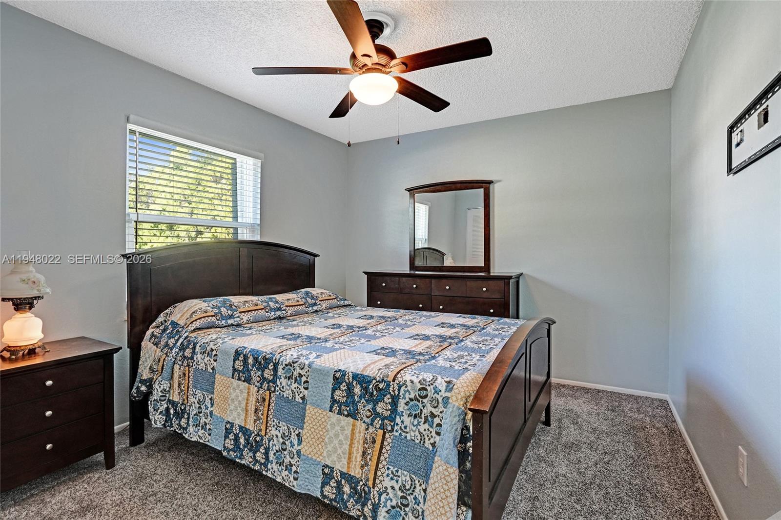 2252 Southeast Rainier Road Port St. Lucie, FL 34952 - Photo 30 of 52 a bedroom with a bed and a chandelier