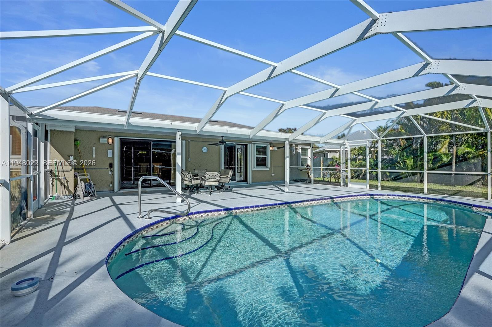 2252 Southeast Rainier Road Port St. Lucie, FL 34952 - Photo 3 of 52 a view of a house with backyard sitting area and porch