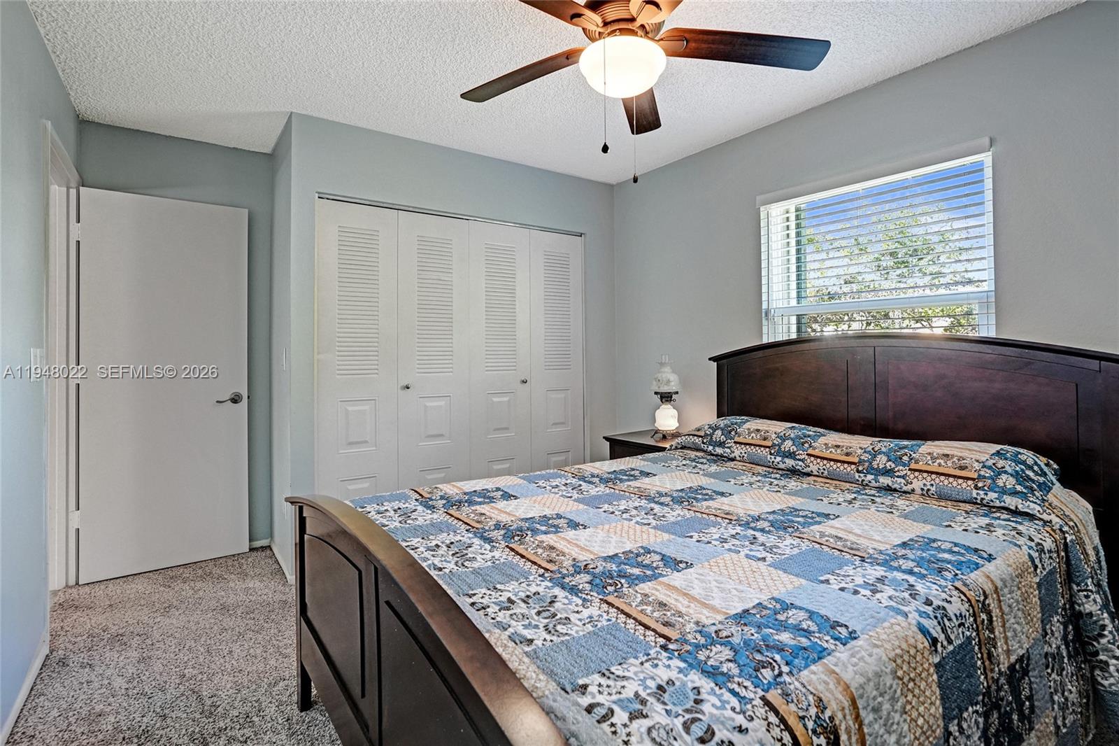 2252 Southeast Rainier Road Port St. Lucie, FL 34952 - Photo 32 of 52 a bedroom with a large bed and a window