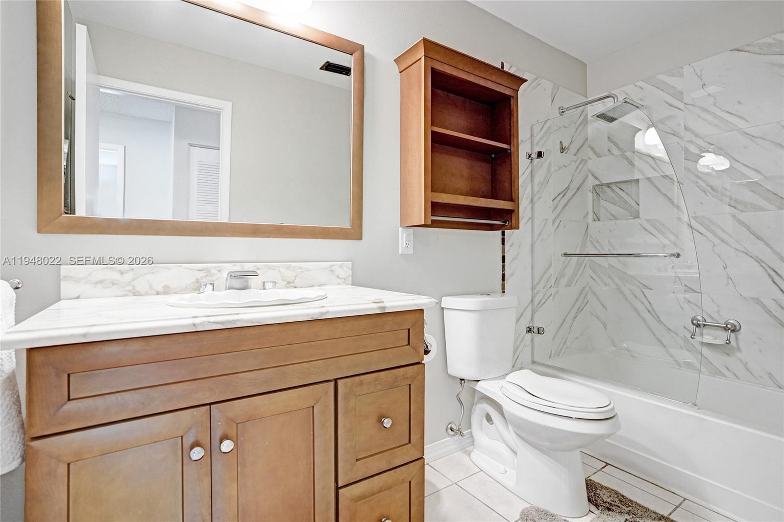 2252 Southeast Rainier Road Port St. Lucie, FL 34952 - Photo 34 of 52 a bathroom with a sink toilet vanity and shower