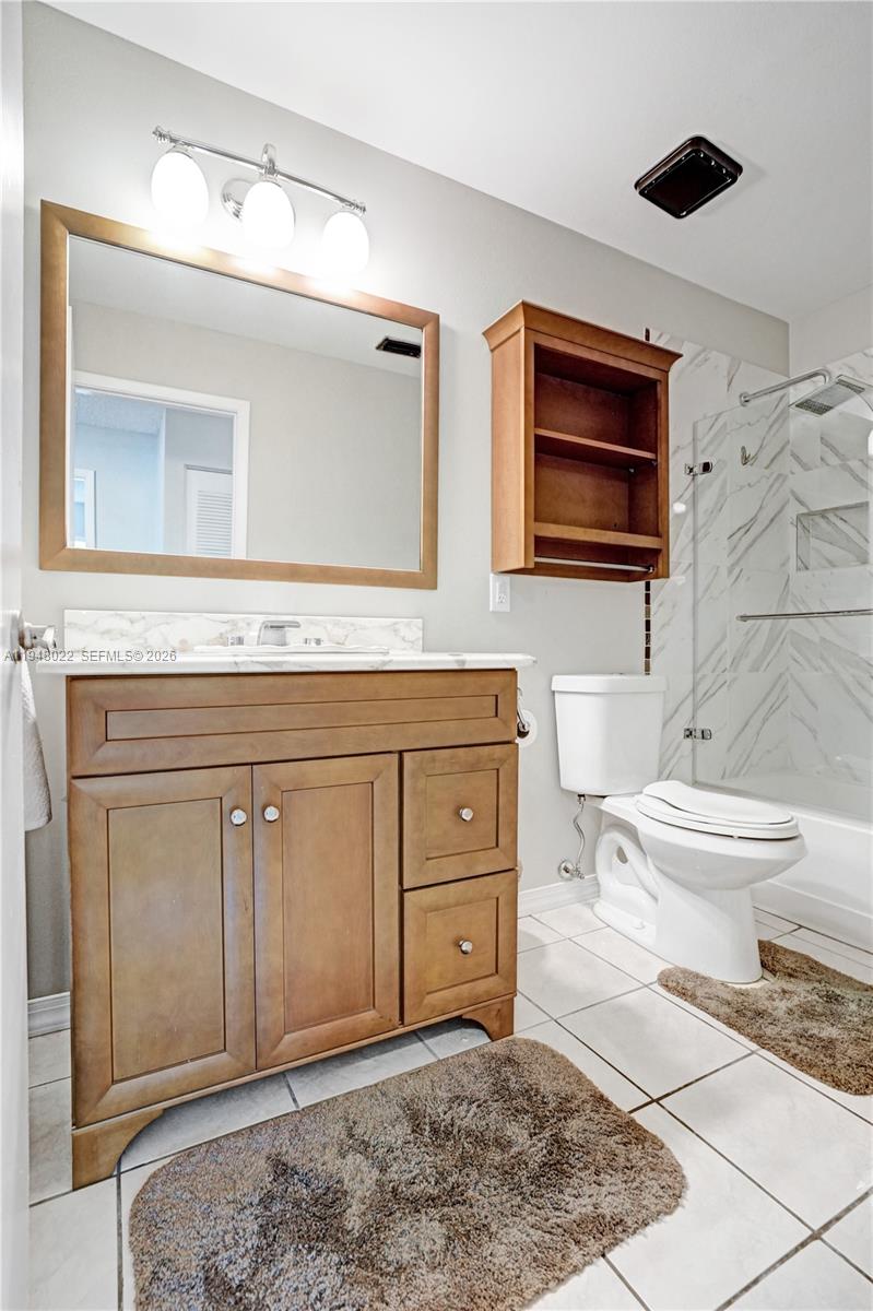 2252 Southeast Rainier Road Port St. Lucie, FL 34952 - Photo 35 of 52 a spacious bathroom with a toilet sink and mirror