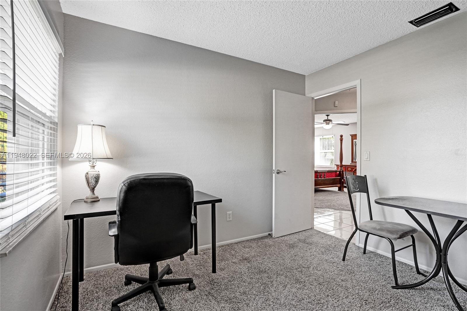 2252 Southeast Rainier Road Port St. Lucie, FL 34952 - Photo 39 of 52 a view of a workspace with furniture and a window