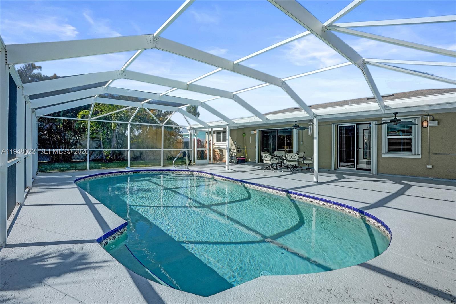 2252 Southeast Rainier Road Port St. Lucie, FL 34952 - Photo 46 of 52 a view of a white building with swimming pool in front of it