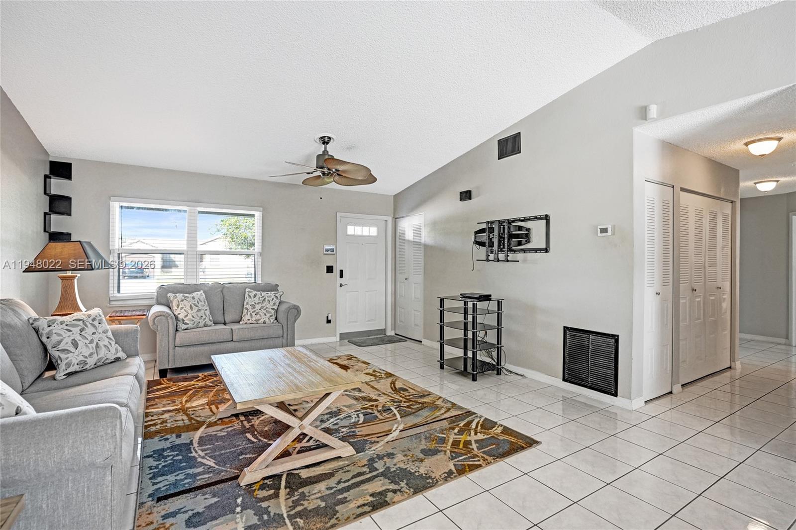 2252 Southeast Rainier Road Port St. Lucie, FL 34952 - Photo 8 of 52 a living room with furniture rug and window