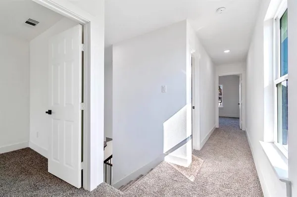 a view of a hallway with two rooms