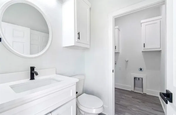 a bathroom with a toilet a sink and mirror
