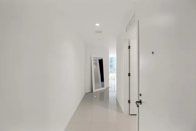 a view of a hallway with closet and hallway