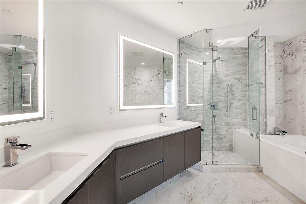 851 Northeast 1st Avenue, Unit 2005 Miami, FL 33132 - Photo 15 of 23 a bathroom with a tub sink shower and mirror