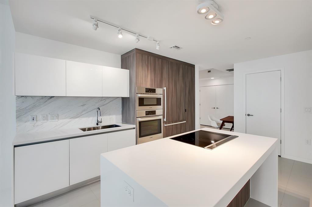 851 Northeast 1st Avenue, Unit 2005 Miami, FL 33132 - Photo 5 of 23 a kitchen with stainless steel appliances a sink and stove top oven