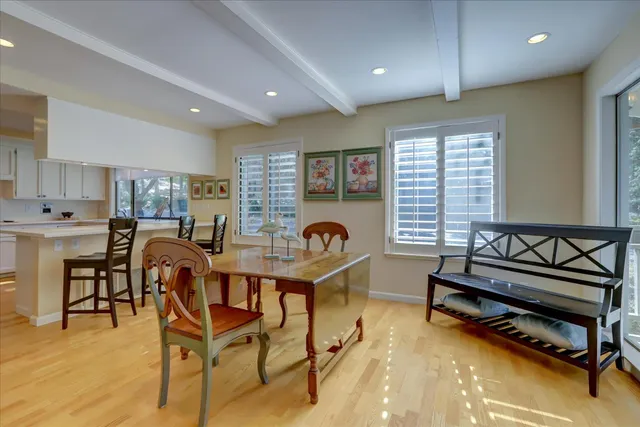 a kitchen with stainless steel appliances wooden floor and cabinets