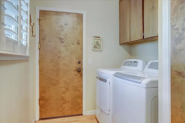 a living room with furniture a flat screen tv and a floor to ceiling window