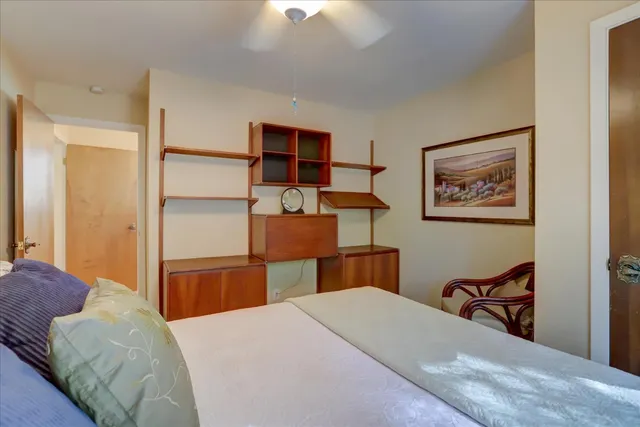 a spacious bedroom with a bed and a couch