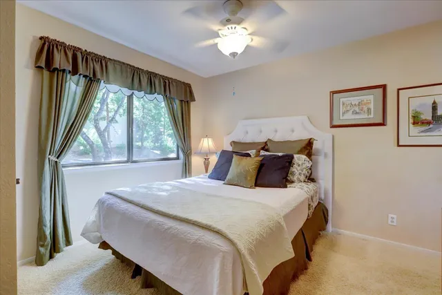 a spacious bedroom with a bed and a couch