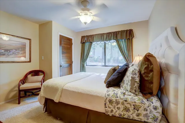 a bedroom with furniture and a flat screen tv