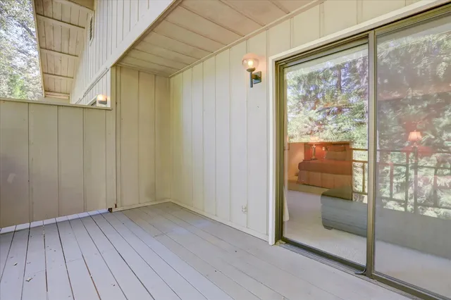 a view of a brick house with wooden fence