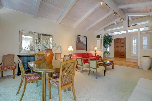 a view of a patio with a table and chairs under an umbrella with wooden floor