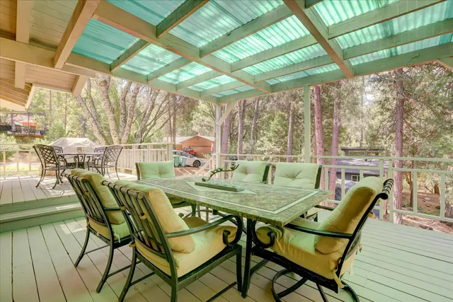 a dining room with furniture a chandelier and wooden floor