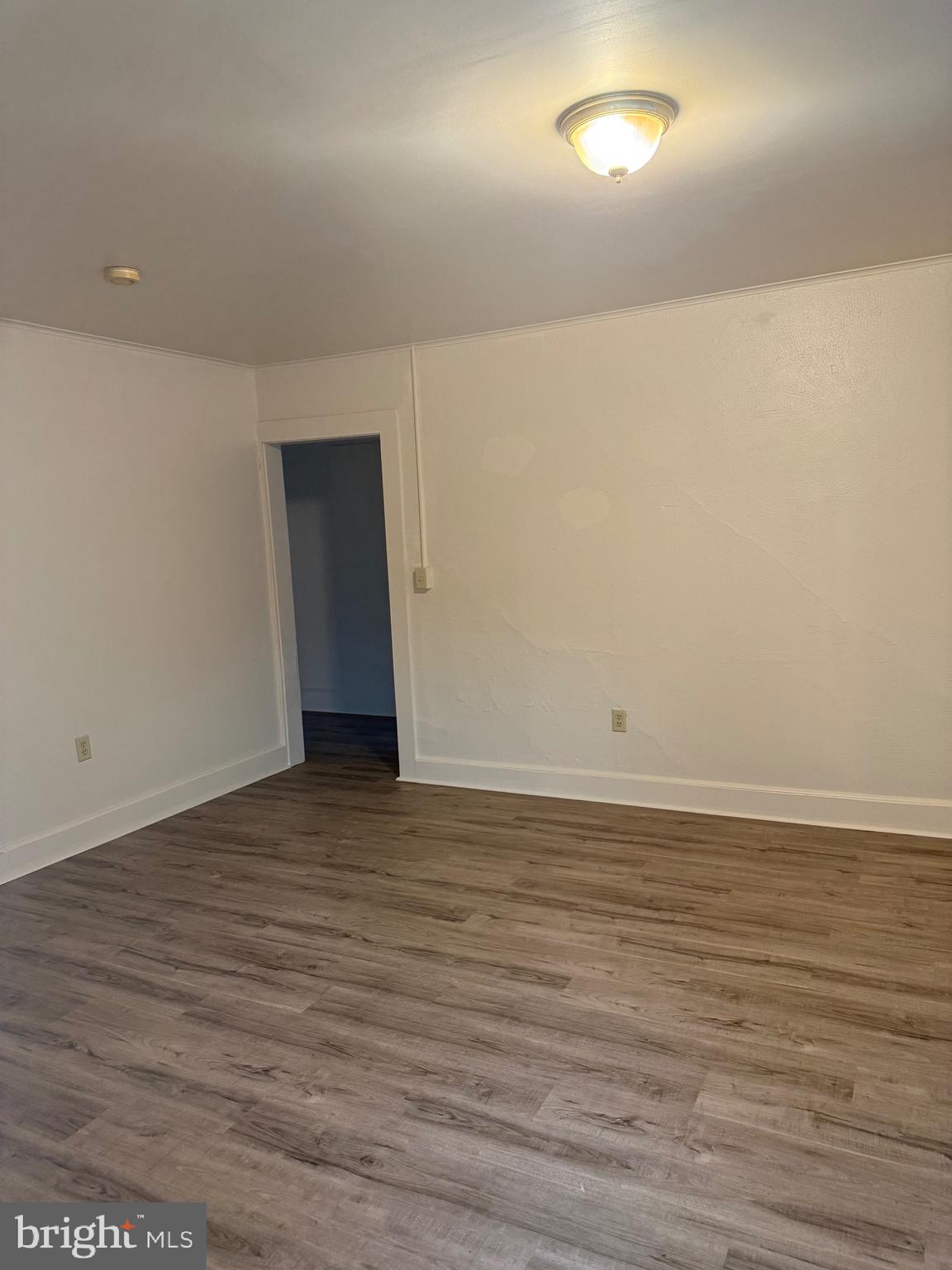 1 Center Street, Unit 2 Port Deposit, MD 21904 - Photo 4 of 7 a view of an empty room with wooden floor and a window