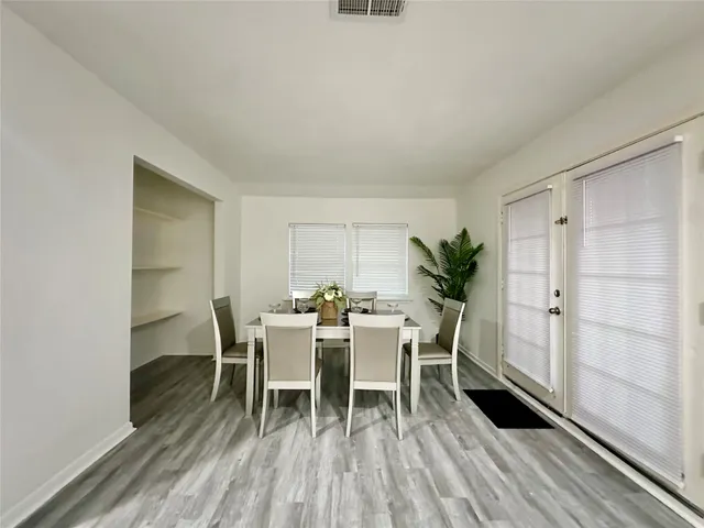 a dining room with furniture and wooden floor