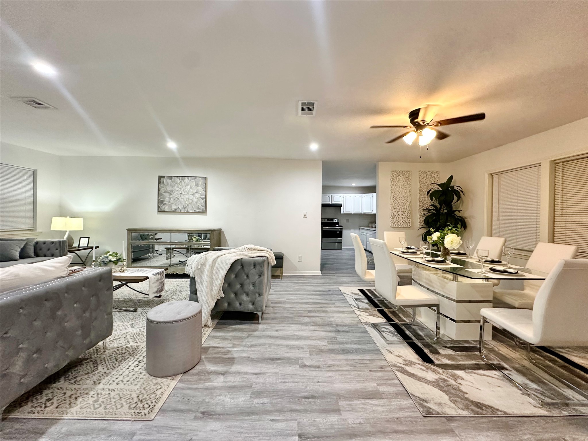 5346 Windswept Lane Houston, TX 77056 - Photo 3 of 20 a living room with furniture a rug and a chandelier