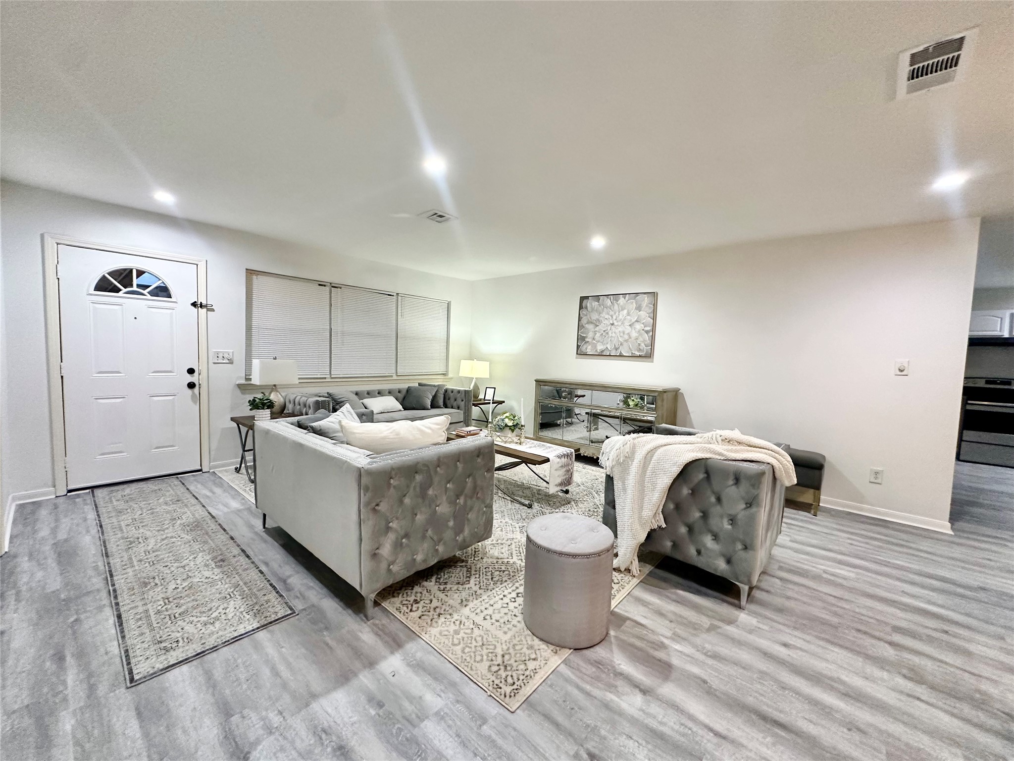 5346 Windswept Lane Houston, TX 77056 - Photo 6 of 20 a living room with furniture a wooden floor and white walls