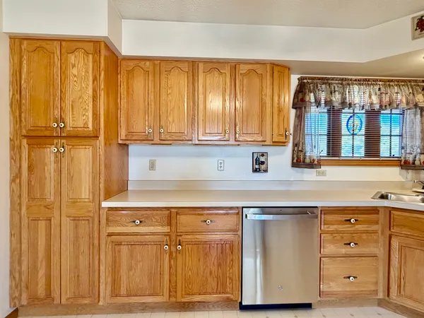a kitchen with stainless steel appliances a stove and cabinets