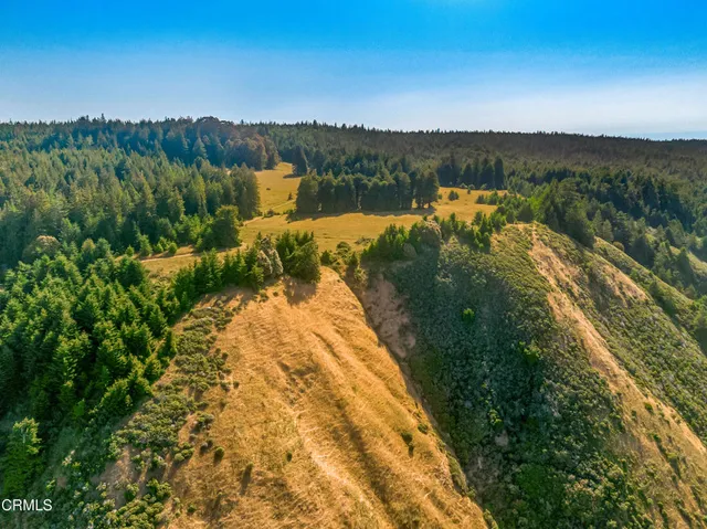 a view of a house with wooden fence