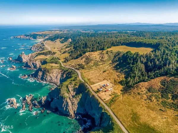an aerial view of a houses with a yard
