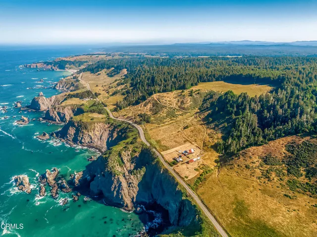 an aerial view of a houses with a yard