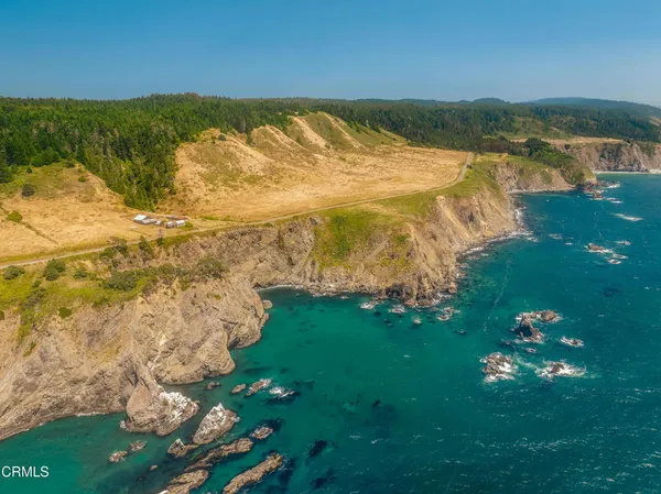 an aerial view of a houses with a yard