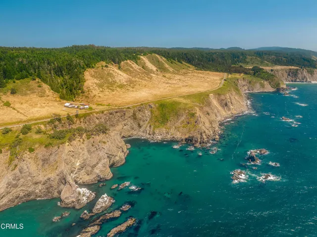 an aerial view of a houses with a yard