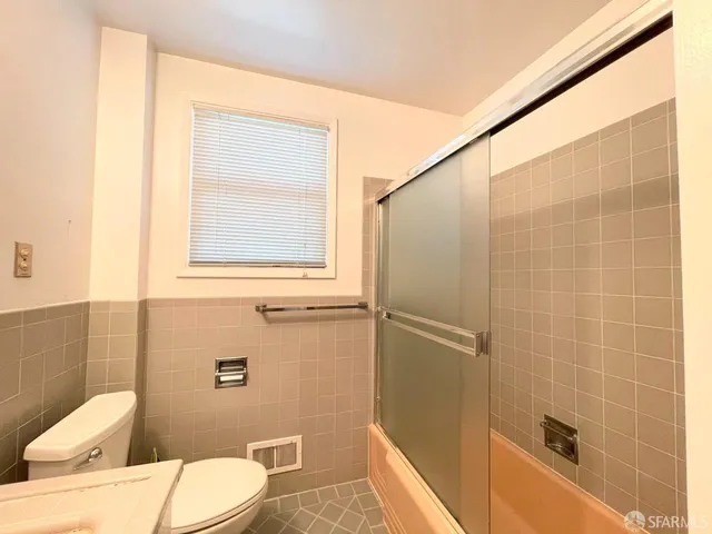 a bathroom with a toilet a sink and shower