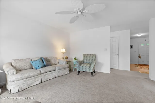a dining room filled chandelier and kitchen view