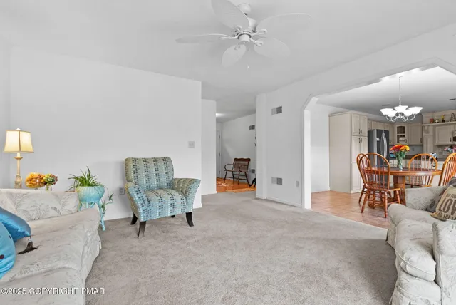a view of a dining room with furniture and chandelier