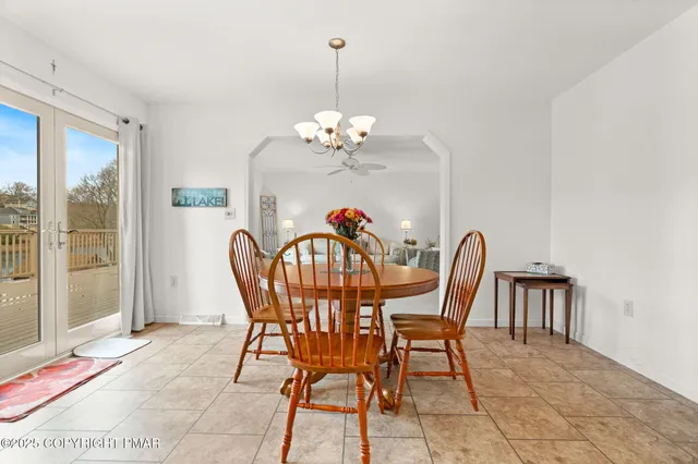 a kitchen with center island table and chairs
