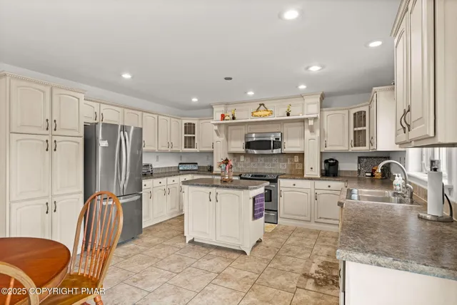 a spacious bedroom with a bed and ceiling fan